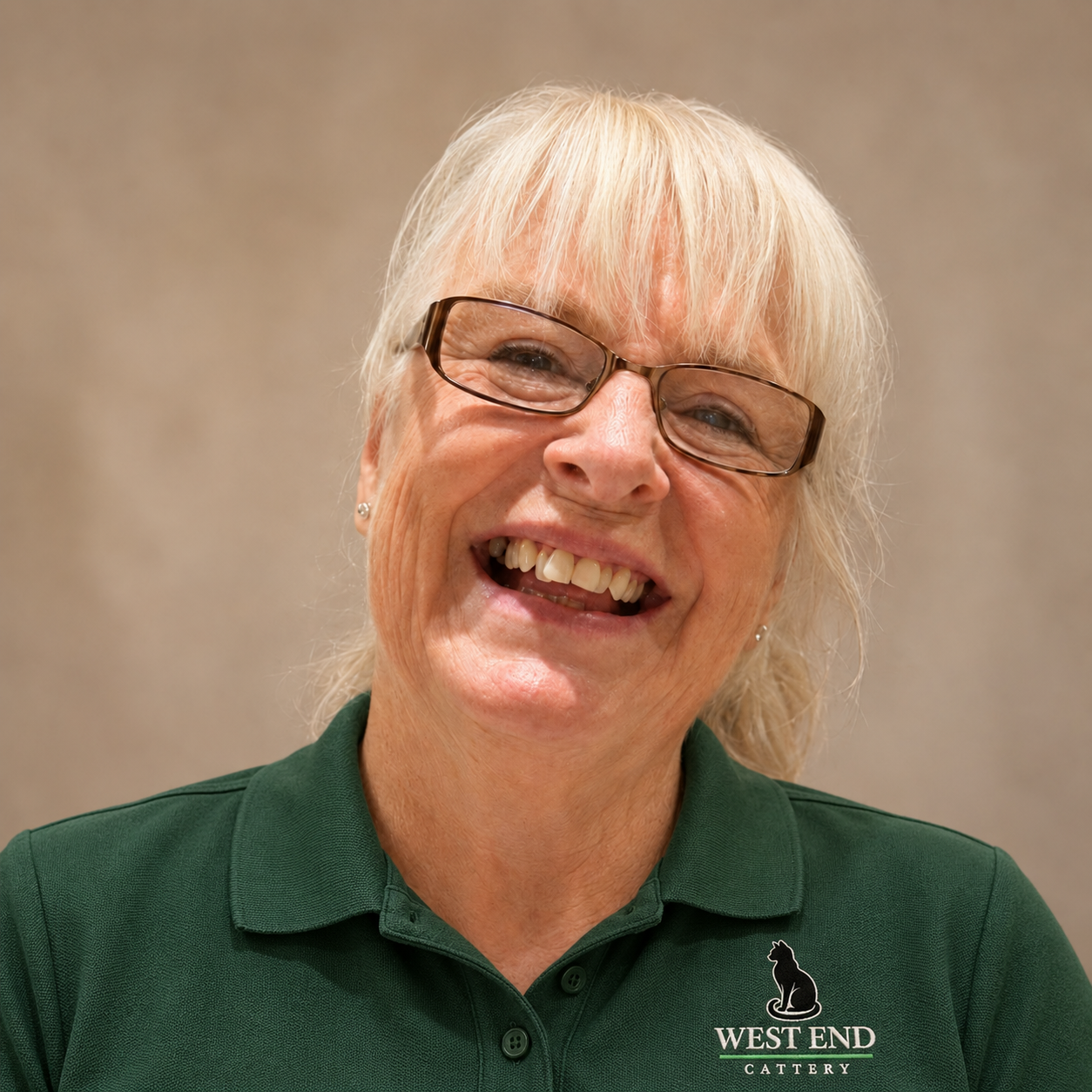 Lois Tucker wearing her green West End Cattery uniform